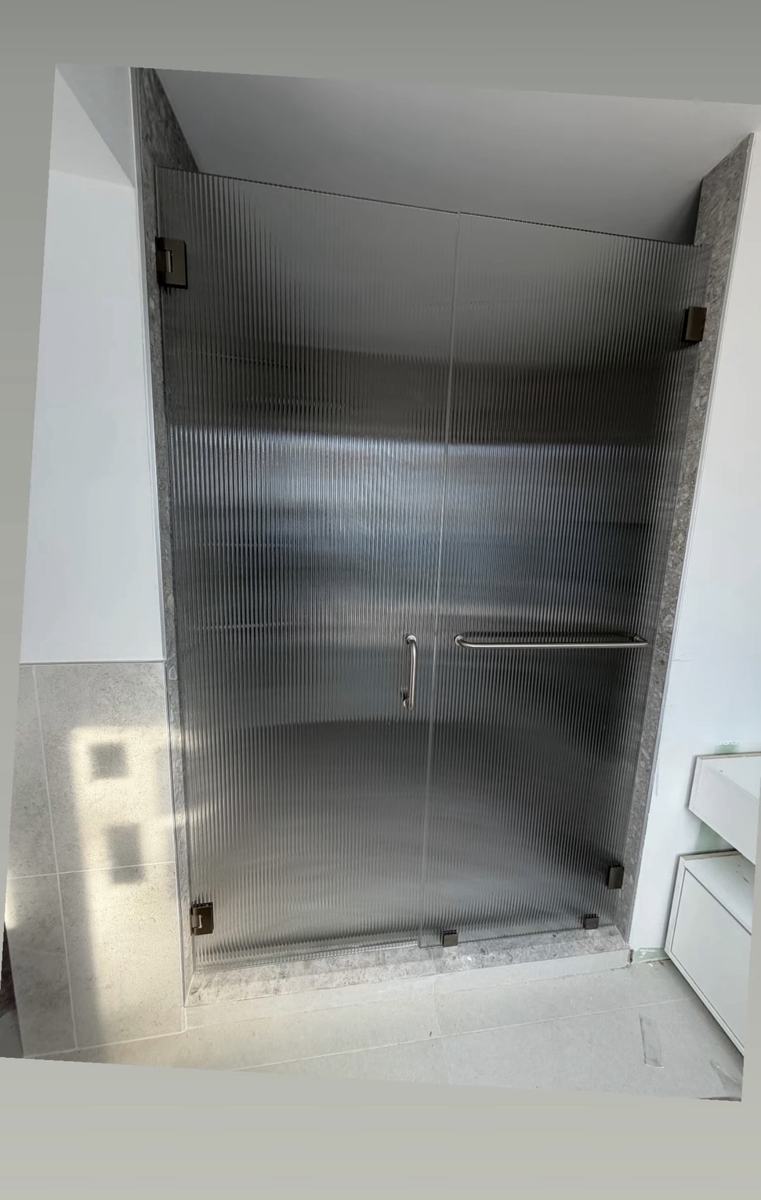 Fluted glass hinged doors with oil-rubbed bronze hardware