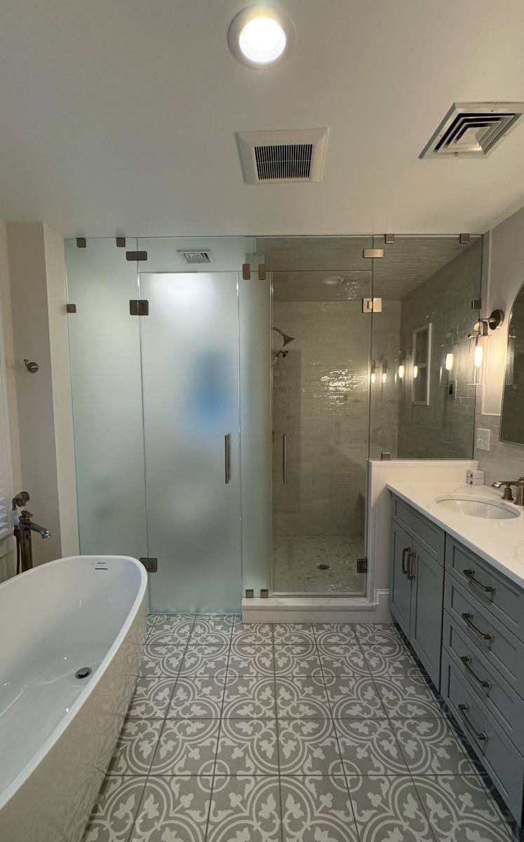 Frosted glass hinged shower enclosure with brushed nickel hardware