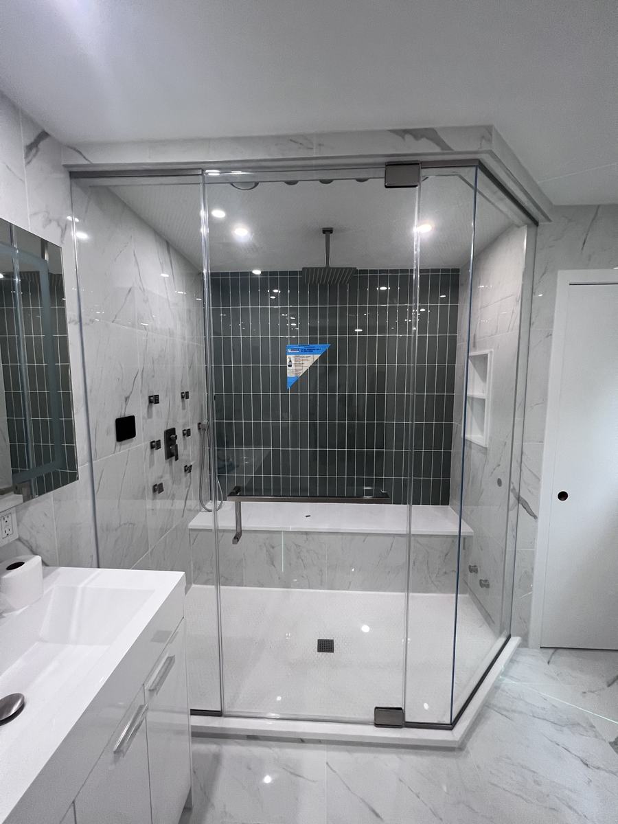 Frameless neo-angle shower enclosure with brushed nickel hardware