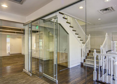 Glass office partition with sliding glass doors