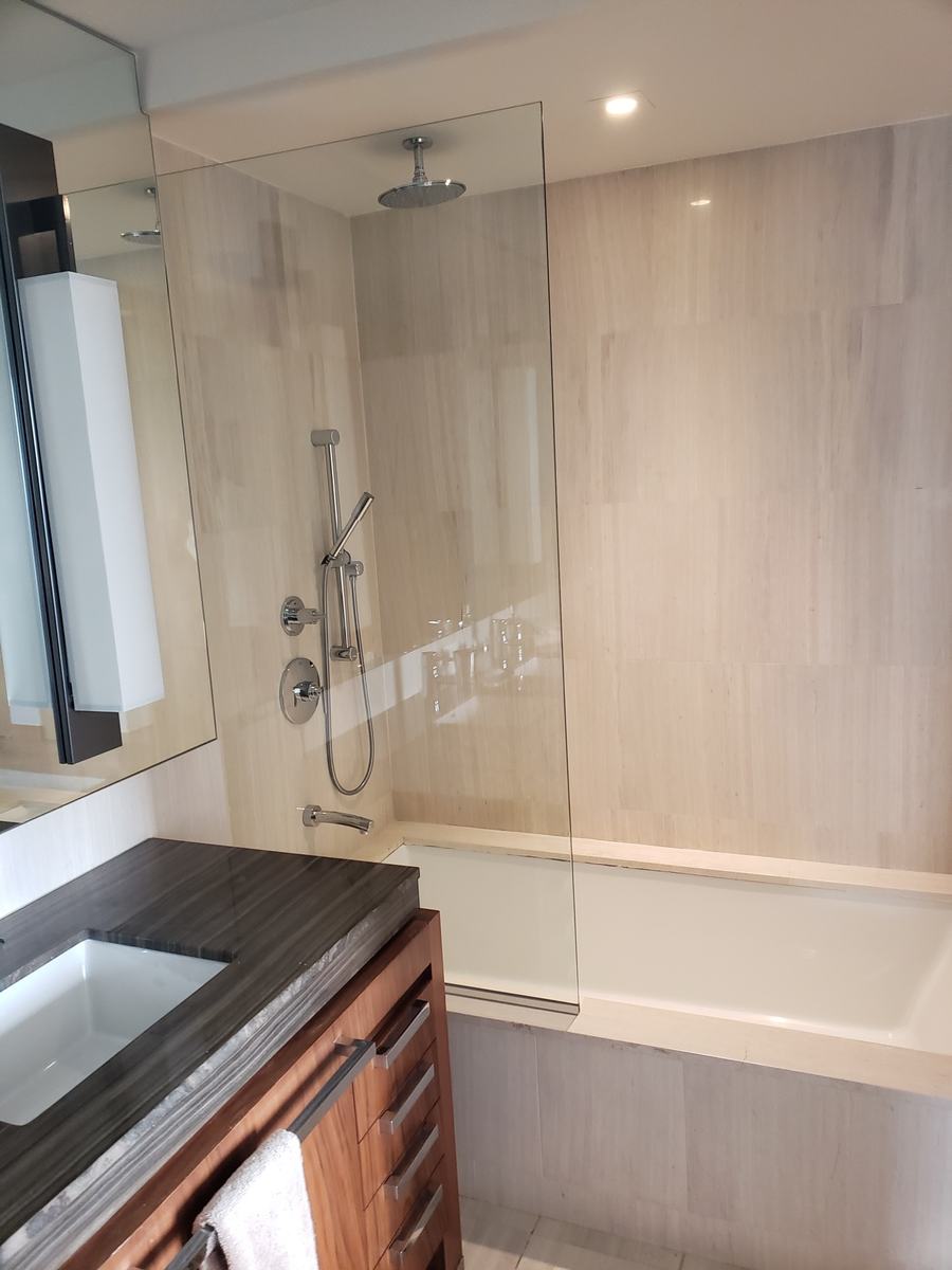 Frameless glass splash panel with chrome hardware