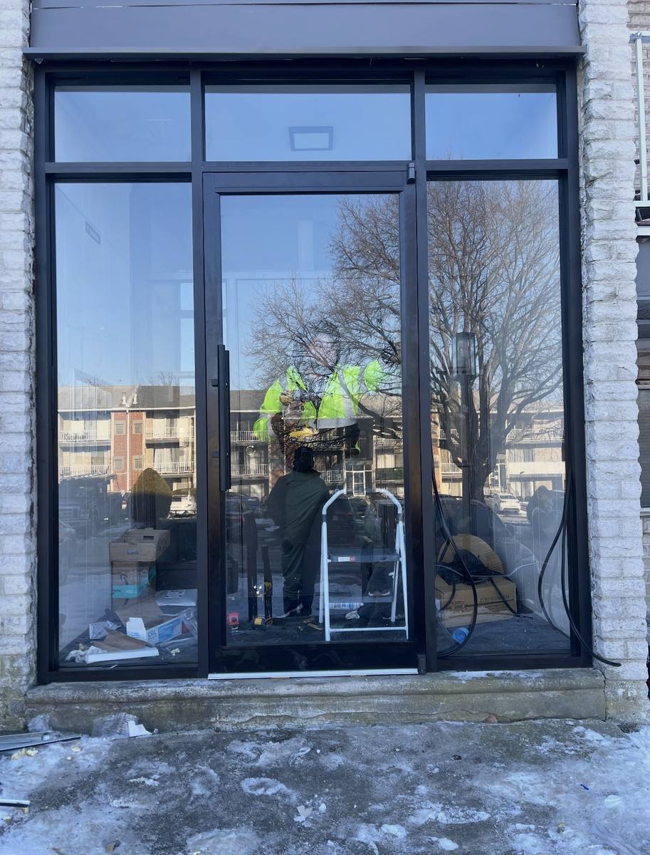 Black-framed glass storefront with entry door