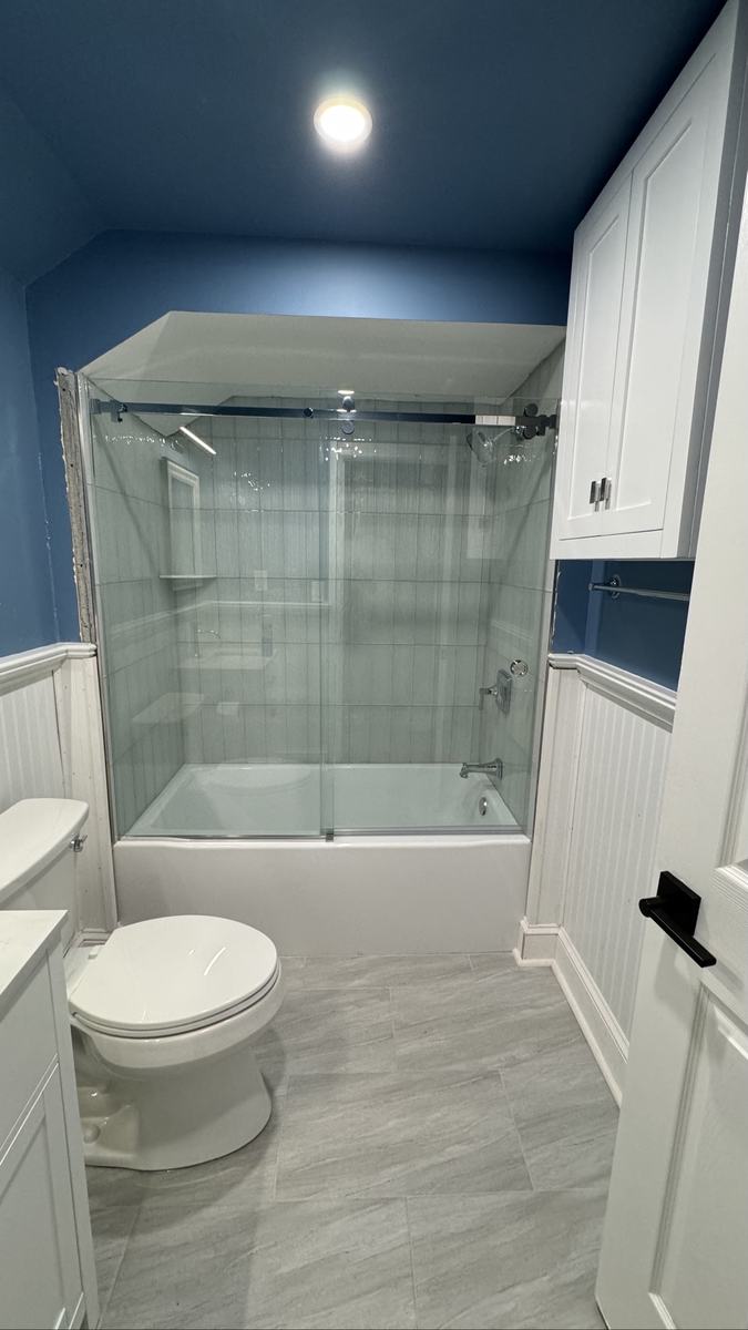 Frameless sliding tub enclosure with chrome hardware