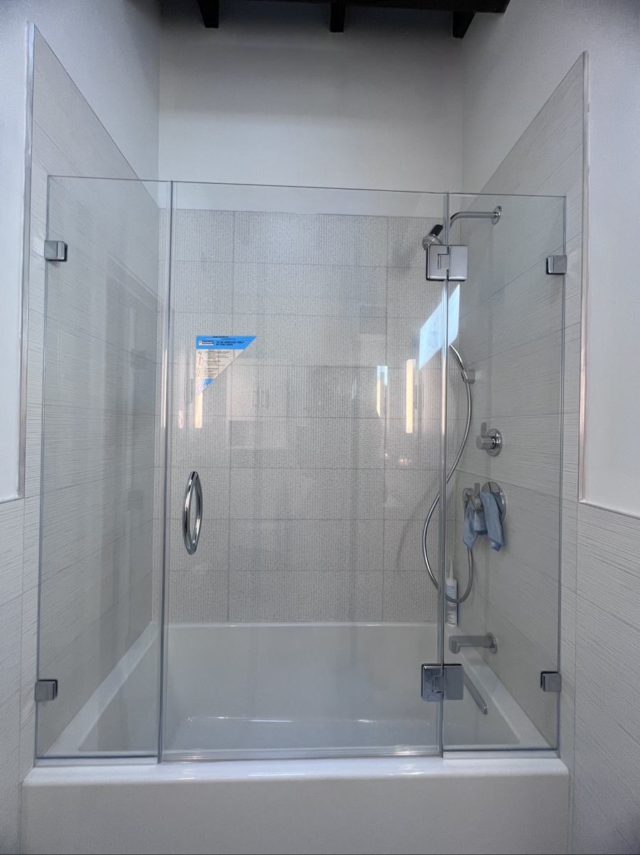 Frameless hinged tub enclosure with chrome handle