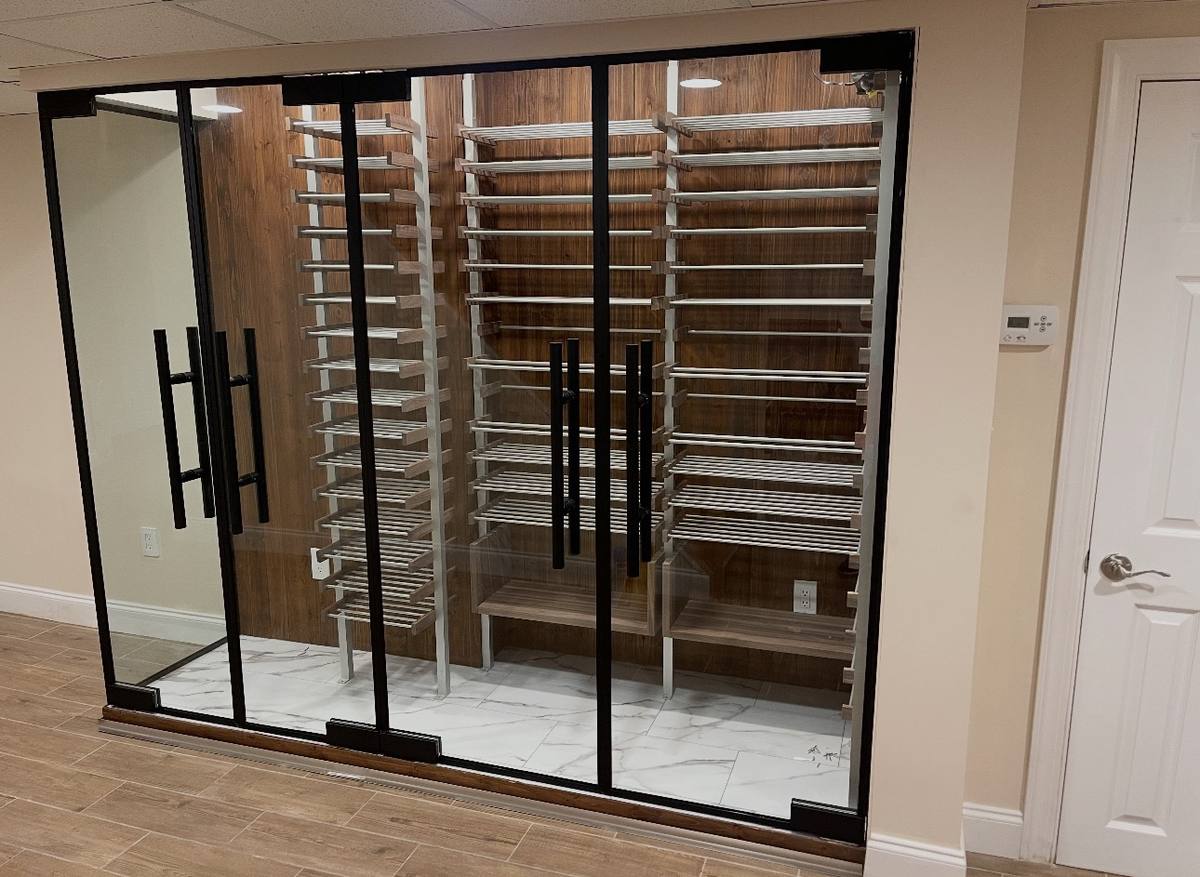 Black-framed glass wine cellar with metal racking