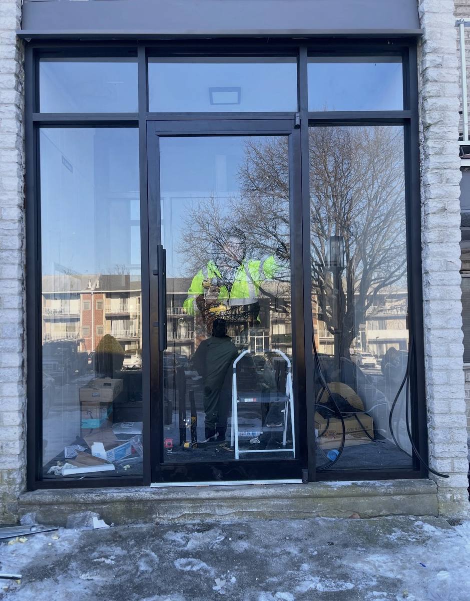 Black-framed glass storefront with entry door
