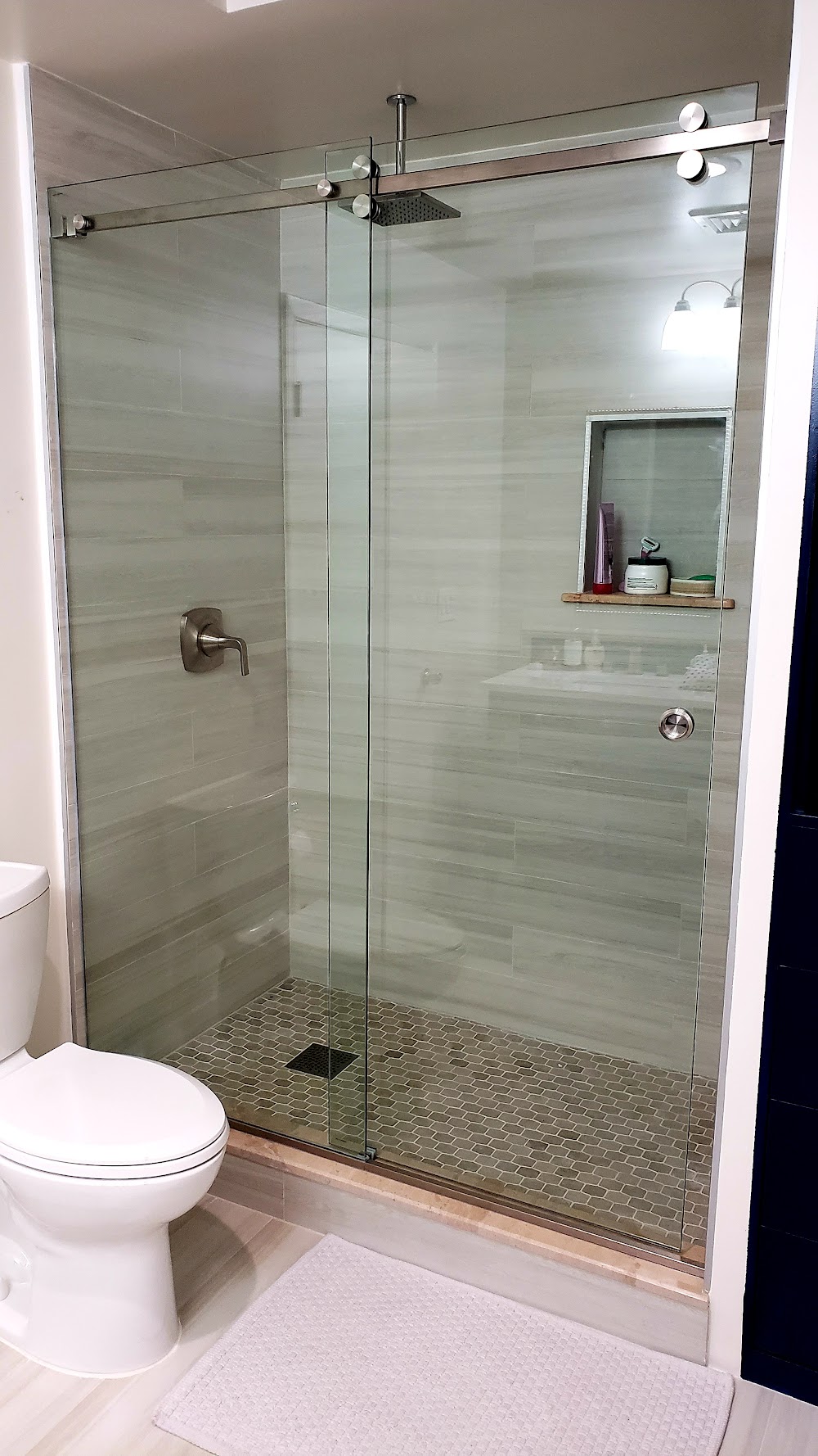 Custom frameless sliding glass shower enclosure